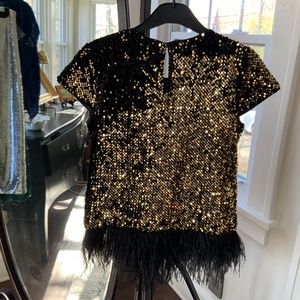Milly.  Gold Metalic with detatchable black ostrich feather fringe at waist